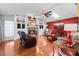 Spacious living room with built-in bookshelves, fireplace, and hardwood floors at 8518 Delaware Dr, Weeki Wachee, FL 34607