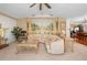 Bright and airy living room showcasing a large sofa, decorative accents, and an open layout leading to the dining area at 8518 Delaware Dr, Weeki Wachee, FL 34607