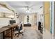 Office setup including a desk, office chair, large area rug, and view to the outside at 8518 Delaware Dr, Weeki Wachee, FL 34607