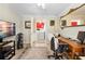 Office setup including a desk, office chair, large area rug, and view to the laundry room at 8518 Delaware Dr, Weeki Wachee, FL 34607