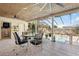 Covered patio area with a ceiling fan, dining table, and view of the screened in pool at 8518 Delaware Dr, Weeki Wachee, FL 34607