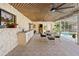 Covered patio area with a ceiling fan, outdoor sink, dining table, and view of the pool at 8518 Delaware Dr, Weeki Wachee, FL 34607
