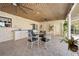 Covered patio area with a ceiling fan, outdoor sink, and dining table with chairs at 8518 Delaware Dr, Weeki Wachee, FL 34607