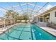 Relax in the screened-in pool area, complete with a poolside patio and lush tropical surroundings at 8518 Delaware Dr, Weeki Wachee, FL 34607