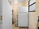 Functional utility room features a refrigerator, freezer, water heater, and electric heater at 8518 Delaware Dr, Weeki Wachee, FL 34607