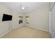 Neutral bedroom with a ceiling fan, closet, and two windows providing natural light at 8748 Laurel N Dr, Pinellas Park, FL 33782