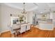 Dining room with hardwood floors, a large window, and seamless access to the kitchen at 8748 Laurel N Dr, Pinellas Park, FL 33782