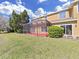 A lovely screened-in lanai offers a great view of the backyard and the mature landscaping at 8906 Iron Oak Ave, Tampa, FL 33647