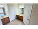 Well-lit bathroom featuring dual vanities, tile flooring, and ample storage space at 8906 Iron Oak Ave, Tampa, FL 33647