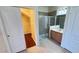 Tiled bathroom showcasing glass shower and an open closet ready for plenty of storage at 8906 Iron Oak Ave, Tampa, FL 33647