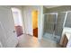 Open concept bathroom featuring standup shower, storage vanity, and sliding closet door at 8906 Iron Oak Ave, Tampa, FL 33647