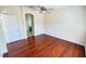Bedroom featuring hardwood floors, a ceiling fan, and an open doorway to another room at 8906 Iron Oak Ave, Tampa, FL 33647
