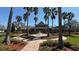 Lovely clubhouse featuring verdant grounds, palm trees, and brick pathway at 8906 Iron Oak Ave, Tampa, FL 33647