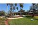 Beautiful clubhouse surrounded by palm trees, a fountain, and lush landscaping at 8906 Iron Oak Ave, Tampa, FL 33647