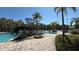 Resort-style community pool featuring a small bridge and lush landscaping at 8906 Iron Oak Ave, Tampa, FL 33647
