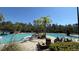 Stunning community pool area with palm trees and plenty of seating at 8906 Iron Oak Ave, Tampa, FL 33647
