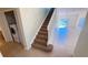 Entryway view of stairway, tile floor, and laundry area with a washing machine at 8906 Iron Oak Ave, Tampa, FL 33647