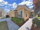 Street view of the home, displaying neat landscaping and complementary blue shutter accents at 8906 Iron Oak Ave, Tampa, FL 33647