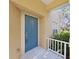 Close-up of a blue front door with white trim, providing a warm and inviting entrance to the home at 8906 Iron Oak Ave, Tampa, FL 33647