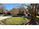 Charming single-story home featuring a well-manicured lawn, covered entry and an attached two car garage at 8906 Iron Oak Ave, Tampa, FL 33647
