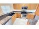 Well-equipped kitchen with granite counters, stainless appliances, and wood cabinets at 8906 Iron Oak Ave, Tampa, FL 33647