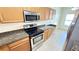 Modern kitchen featuring stainless appliances, granite countertops, and tiled flooring at 8906 Iron Oak Ave, Tampa, FL 33647