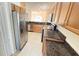Spacious kitchen featuring stainless appliances, granite countertops, and tile floors at 8906 Iron Oak Ave, Tampa, FL 33647