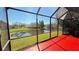 Serene view of the pond from the screened lanai, highlighting the peaceful outdoor space at 8906 Iron Oak Ave, Tampa, FL 33647