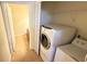 Laundry area with washer and dryer; tile floor and closet storage at 8906 Iron Oak Ave, Tampa, FL 33647