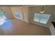Bright living room featuring tile flooring, natural light, and sliding glass doors leading to outdoor space at 8906 Iron Oak Ave, Tampa, FL 33647