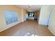 Spacious living room featuring tile flooring, neutral walls, and a view to the kitchen at 8906 Iron Oak Ave, Tampa, FL 33647