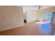 Open living area featuring tile floors, neutral paint, and sliding glass doors to the screened lanai at 8906 Iron Oak Ave, Tampa, FL 33647
