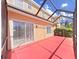 Relaxing screened porch with views of the backyard and the surrounding greenery at 8906 Iron Oak Ave, Tampa, FL 33647
