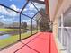 Screened porch overlooks a serene pond, offering a peaceful outdoor living space with great views at 8906 Iron Oak Ave, Tampa, FL 33647