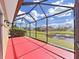 Lovely screened-in porch overlooking a beautiful pond and lush greenery, perfect for relaxing outdoors at 8906 Iron Oak Ave, Tampa, FL 33647
