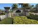 Community entrance sign for Grand Oak Club, framed by manicured landscaping at 8906 Iron Oak Ave, Tampa, FL 33647