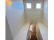 Bright stairwell featuring sconce lighting, leading to the upper or lower levels of the house at 8906 Iron Oak Ave, Tampa, FL 33647