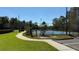 Well-maintained community tennis courts near a manicured lawn at 8906 Iron Oak Ave, Tampa, FL 33647