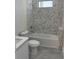 Contemporary bathroom with marble tile, a soaking tub, and modern fixtures at 9 Tee View Rd, Rotonda West, FL 33947