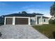 Charming one-story home with a three-car garage and a neatly paved driveway at 9 Tee View Rd, Rotonda West, FL 33947