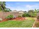 Lush backyard featuring a landscaped area with seating, plants and a well-maintained lawn at 9408 Bluebird Dr, Tampa, FL 33647