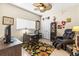Bedroom features a ceiling fan, a closet, and a desk at 9408 Bluebird Dr, Tampa, FL 33647