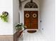 Inviting front entrance with double doors, decorative wreaths, tiled floor, and a charming floral display at 9408 Bluebird Dr, Tampa, FL 33647