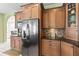 Close-up of a kitchen with stainless steel appliances, custom cabinets, and a mosaic backsplash, great for cooking at 9408 Bluebird Dr, Tampa, FL 33647