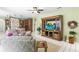 Spacious living room with tile floors, a ceiling fan, and an entertainment center at 9408 Bluebird Dr, Tampa, FL 33647
