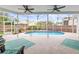 Sparkling swimming pool in a screened lanai, offering a relaxing outdoor space with comfortable seating at 9408 Bluebird Dr, Tampa, FL 33647