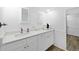 White bathroom with a white countertop vanity, dual mirrors, and wood-look flooring at 1001 Crocker Ln, Plant City, FL 33565