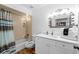 Bathroom with a vanity with white countertops, a mirror, and a tub shower at 1001 Crocker Ln, Plant City, FL 33565