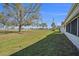 Expansive backyard view showcasing the lush lawn and mature trees at 10047 41St N St # 10047, Pinellas Park, FL 33782