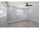 Bedroom featuring modern gray walls, luxury vinyl flooring, and a ceiling fan at 10047 41St N St # 10047, Pinellas Park, FL 33782